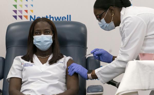Sandra Lindsay (left) a nurse at Long Island Jewish Medical Center, is inoculated with the Pfizer-BioNTech COVID-19 vaccine by Dr. Michelle Chester on Monday in New York. Sandra Lindsay (left) a nurse at Long Island Jewish Medical Center, is inoculated with the Pfizer-BioNTech COVID-19 vaccine by Dr. Michelle Chester on Monday in New York.