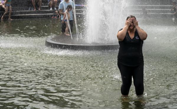 A woman cools off in the fountain at Washington Square Park in New York. Temperatures at or close to 100 degrees are expected in the city this weekend. A woman cools off in the fountain at Washington Square Park in New York. Temperatures at or close to 100 degrees are expected in the city this weekend.