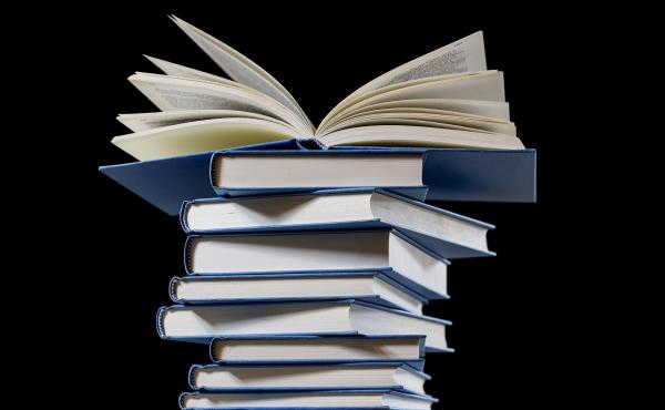 A stack of books on a black background. A stack of books on a black background.