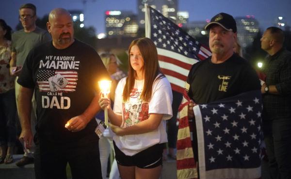 Sydney Robison, center, looks on during a vigil for U.S. Marines Staff Sgt. Taylor Hoover Sunday in Salt Lake City. Hoover was among the 13 U.S. troops killed in a suicide bombing at Kabul airport. Sydney Robison, center, looks on during a vigil for U.S. Marines Staff Sgt. Taylor Hoover Sunday in Salt Lake City. Hoover was among the 13 U.S. troops killed in a suicide bombing at Kabul airport.