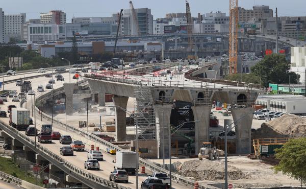 Workers improve a busy highway intersection in Miami. President Biden is proposing roughly $2 trillion to invest in the nation's infrastructure. His plan includes improvements for roads, bridges, transit, water systems, electric grids and Internet access. Workers improve a busy highway intersection in Miami. President Biden is proposing roughly $2 trillion to invest in the nation's infrastructure. His plan includes improvements for roads, bridges, transit, water systems, electric grids and Internet access.