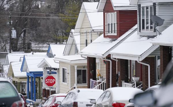 Snow blankets a row of homes after a snowstorm in Bellevue, Ky., on Friday. Snow blankets a row of homes after a snowstorm in Bellevue, Ky., on Friday.