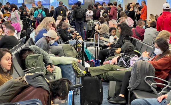 Dr. Anthony Fauci, chief medical adviser to President Biden, cites the U.S. vaccination program and previous widespread transmission of the coronavirus as reasons why the U.S. is not now under pandemic conditions. Here, travelers wait at Miami Internation Dr. Anthony Fauci, chief medical adviser to President Biden, cites the U.S. vaccination program and previous widespread transmission of the coronavirus as reasons why the U.S. is not now under pandemic conditions. Here, travelers wait at Miami Internation