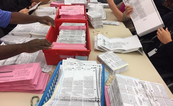 Election workers sort through unprocessed vote-by-mail ballots at the Sacramento County Registrar of Voters office on Monday. Election workers sort through unprocessed vote-by-mail ballots at the Sacramento County Registrar of Voters office on Monday.