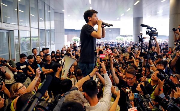 Pro-democracy activist Joshua Wong addresses the crowd outside Hong Kong's Legislative Council on Monday, during a demonstration demanding that Hong Kong's leaders step down and permanently withdraw an extradition bill. Pro-democracy activist Joshua Wong addresses the crowd outside Hong Kong's Legislative Council on Monday, during a demonstration demanding that Hong Kong's leaders step down and permanently withdraw an extradition bill.