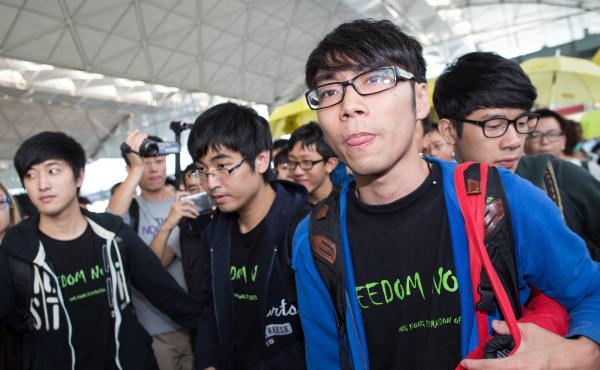 Federation of Students representatives Alex Chow Yong-kang (second left), Eason Chung Yiu-wa (second right) and Nathan Law Kwun-chung (right) talk to the media before trying to board a plane to Beijing on Saturday. They were told that Beijing authorities Federation of Students representatives Alex Chow Yong-kang (second left), Eason Chung Yiu-wa (second right) and Nathan Law Kwun-chung (right) talk to the media before trying to board a plane to Beijing on Saturday. They were told that Beijing authorities