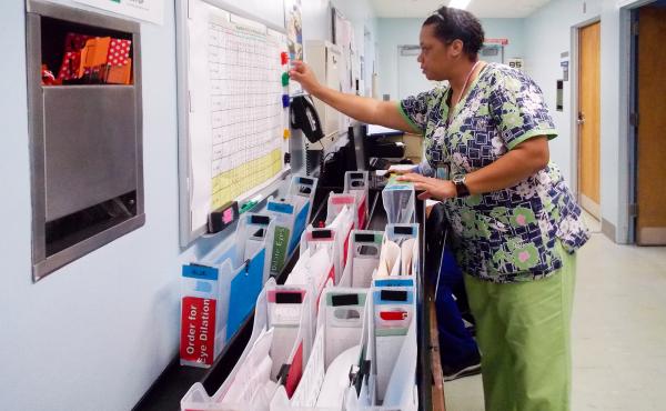 Nursing attendant Tracie Bell helps manage patients at the ophthalmology clinic at Los Angeles County Harbor-UCLA Medical Center. The clinic created a color-coded system to reduce wait times for patients. Nursing attendant Tracie Bell helps manage patients at the ophthalmology clinic at Los Angeles County Harbor-UCLA Medical Center. The clinic created a color-coded system to reduce wait times for patients.