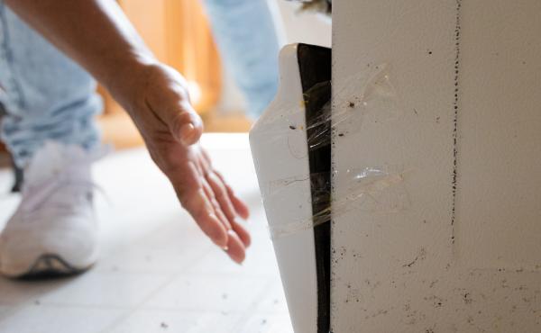 The bottom of María Lara's oven is broken and full of mice feces. It is held in place with packing tape. The bottom of María Lara's oven is broken and full of mice feces. It is held in place with packing tape.