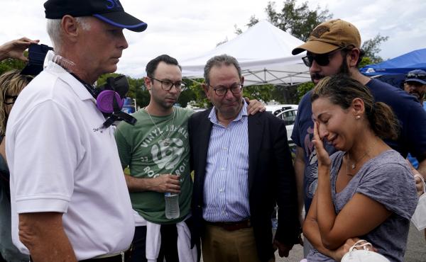 Charles Burkett, mayor of Surfside, Fla., (left) talks with Rachel Spiegel, whose mother is missing in the Champlain Towers South collapse. Charles Burkett, mayor of Surfside, Fla., (left) talks with Rachel Spiegel, whose mother is missing in the Champlain Towers South collapse.