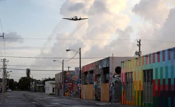 A plane sprays pesticide over the Wynwood neighborhood of Miami on Aug. 6. That's just one way health officials are battling back Zika-carrying mosquitoes in the area. A plane sprays pesticide over the Wynwood neighborhood of Miami on Aug. 6. That's just one way health officials are battling back Zika-carrying mosquitoes in the area.