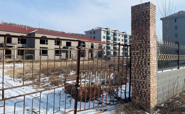 According to Zhang Zhixiong's family, Juxin Mining Co. paid for several village infrastructure projects, including building new apartment complexes for local residents. The buildings were weeks away from completion before Zhang was arrested and now stand According to Zhang Zhixiong's family, Juxin Mining Co. paid for several village infrastructure projects, including building new apartment complexes for local residents. The buildings were weeks away from completion before Zhang was arrested and now stand