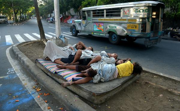 Street children sleep on a discarded mattress on a center island near a road crossing in Manila, Philippines, in April. After 15 years of the Millennium Development Goals, Asia as a region has had the fastest progress, reports the U.N., yet hundreds of mi Street children sleep on a discarded mattress on a center island near a road crossing in Manila, Philippines, in April. After 15 years of the Millennium Development Goals, Asia as a region has had the fastest progress, reports the U.N., yet hundreds of mi