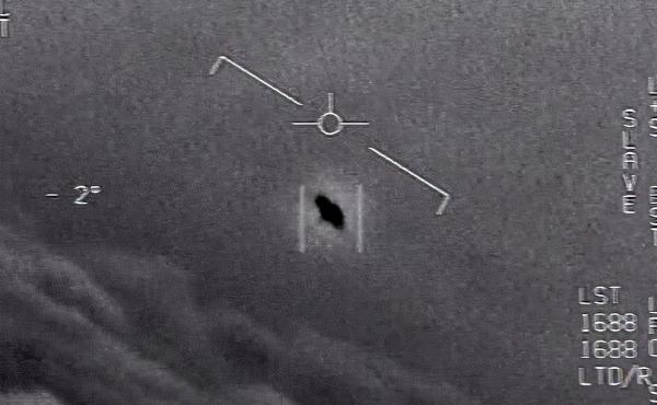 In an image from video footage from 2015, an unexplained object is seen at center as it soars among the clouds, traveling against the wind. "There's a whole fleet of them," a naval aviator tells another, though only one indistinct object is shown. In an image from video footage from 2015, an unexplained object is seen at center as it soars among the clouds, traveling against the wind. "There's a whole fleet of them," a naval aviator tells another, though only one indistinct object is shown.