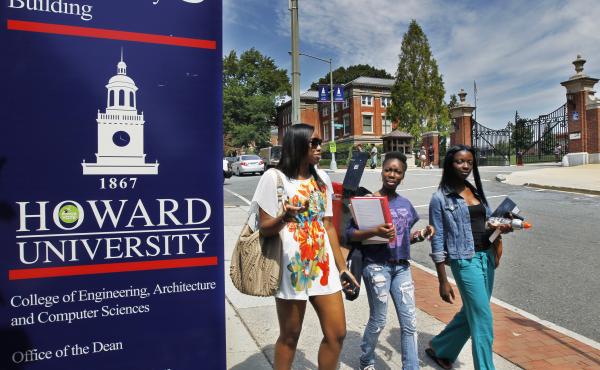 Howard University students walk near the university's main gate. Howard University students walk near the university's main gate.