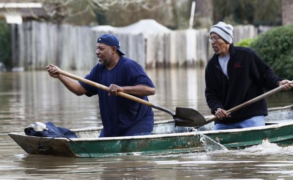 Jackson, Miss., residents use shovels to work their way through Pearl River floodwaters on Sunday. Jackson, Miss., residents use shovels to work their way through Pearl River floodwaters on Sunday.