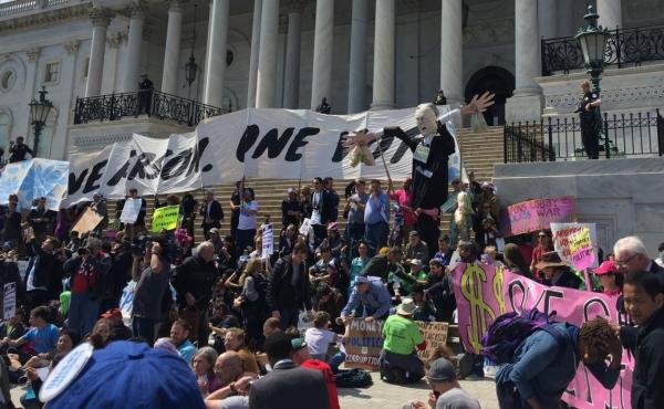 Protesters with a coalition of progressive groups sit in front of the U.S. Capitol steps Monday as part of the Democracy Spring demonstration. Protesters with a coalition of progressive groups sit in front of the U.S. Capitol steps Monday as part of the Democracy Spring demonstration.