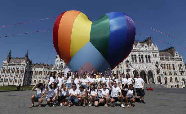 Activists pose for a photo after raising a large rainbow heart in front of Hungary's parliament building in Budapest on Thursday. The activists are protesting against a new law they say discriminates against and marginalizes LGBTQ people. Activists pose for a photo after raising a large rainbow heart in front of Hungary's parliament building in Budapest on Thursday. The activists are protesting against a new law they say discriminates against and marginalizes LGBTQ people.