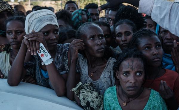 Ethiopians wait for food distribution in front of a warehouse at Um Raquba refugee camp in Gedaref, eastern Sudan, on Dec. 1. Ethiopians wait for food distribution in front of a warehouse at Um Raquba refugee camp in Gedaref, eastern Sudan, on Dec. 1.