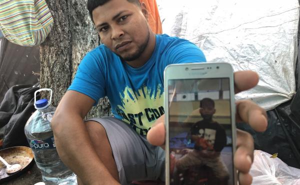 Migrant parents in the tent camps in Matamoros, Mexico, are sending their kids across the border and taking advantage of the rule that unaccompanied children can't be returned to Mexico. Here, Alexis Martinez holds a cellphone photo of his 7-year-old son Migrant parents in the tent camps in Matamoros, Mexico, are sending their kids across the border and taking advantage of the rule that unaccompanied children can't be returned to Mexico. Here, Alexis Martinez holds a cellphone photo of his 7-year-old son