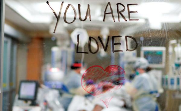 Caregivers working with COVID-19 patients in a Barnes-Jewish Hospital intensive care unit write a message of love and support on the glass door facing a patient's room. Caregivers working with COVID-19 patients in a Barnes-Jewish Hospital intensive care unit write a message of love and support on the glass door facing a patient's room.