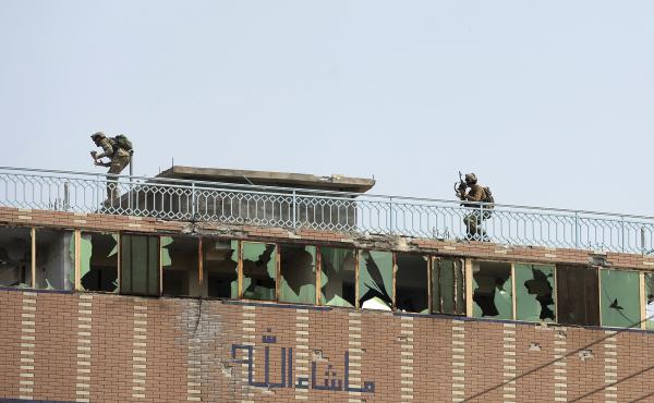 Afghan security personnel take position on the top of a building where insurgents were hiding in the city of Jalalabad, Afghanistan, on Monday. The day before, militants attacked a prison holding many ISIS members. Afghan security personnel take position on the top of a building where insurgents were hiding in the city of Jalalabad, Afghanistan, on Monday. The day before, militants attacked a prison holding many ISIS members.