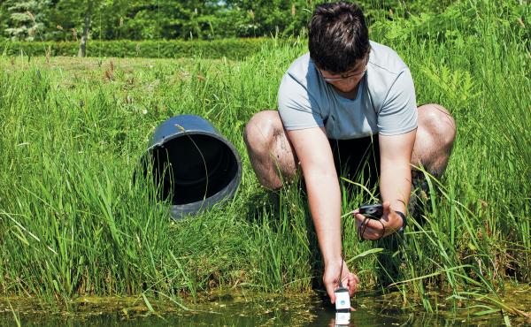 A volunteer uses an AVKO test kit to check water for sodium, calcium and potassium. A volunteer uses an AVKO test kit to check water for sodium, calcium and potassium.