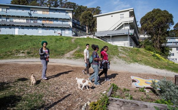 Uzuri Pease-Greene, right, leads a walk through the public housing complex in the Potrero Hill neighborhood of San Francisco where her family lives. She is working to have the old buildings replaced. Uzuri Pease-Greene, right, leads a walk through the public housing complex in the Potrero Hill neighborhood of San Francisco where her family lives. She is working to have the old buildings replaced.