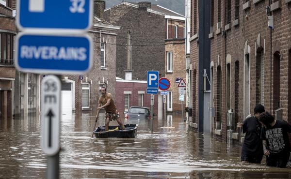 A man rows a boat down a residential street after flooding in Liège, Belgium, on Friday. A man rows a boat down a residential street after flooding in Liège, Belgium, on Friday.