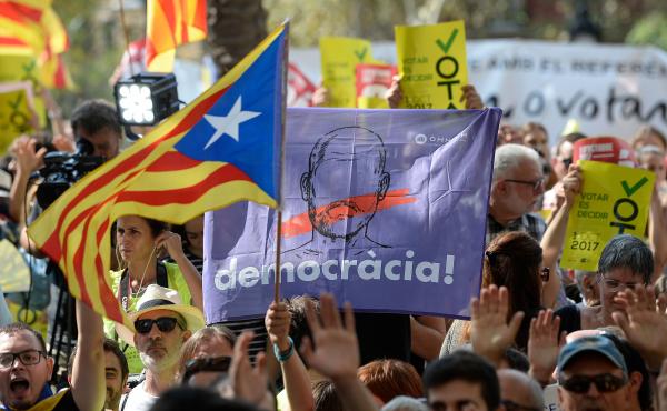 People hold Catalan pro-independence flags outside the high court in Barcelona, Spain, on Thursday. After a daylong protest that lasted well into the night, several thousand independence supporters gathered again in front of the high court in what influen People hold Catalan pro-independence flags outside the high court in Barcelona, Spain, on Thursday. After a daylong protest that lasted well into the night, several thousand independence supporters gathered again in front of the high court in what influen