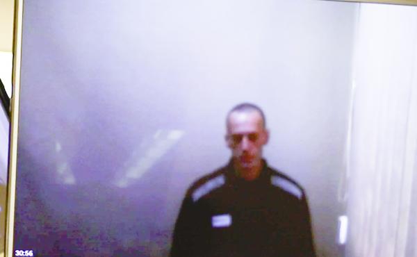 In this photo taken from a video provided by the Babushkinsky District Court in Moscow on Thursday, Russian opposition leader Alexei Navalny is seen during a hearing on charges of defamation. In this photo taken from a video provided by the Babushkinsky District Court in Moscow on Thursday, Russian opposition leader Alexei Navalny is seen during a hearing on charges of defamation.