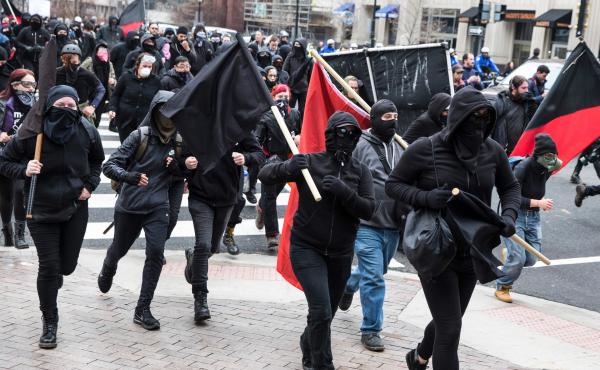 Protestors run through the street before the inauguration of Donald Trump. Protestors run through the street before the inauguration of Donald Trump.