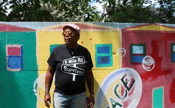 Detroit resident Teresa Moore, who has lived in the city's 8 Mile Road neighborhood for 59 years, stands in front of what she calls a "segregation wall." Detroit resident Teresa Moore, who has lived in the city's 8 Mile Road neighborhood for 59 years, stands in front of what she calls a "segregation wall."