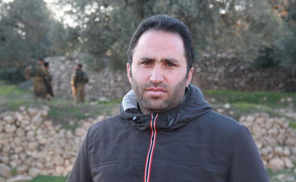 Palestinian activist Issa Amro advocates nonviolence in the West Bank city of Hebron. He recently talked a teenage girl out of an attack, but acknowledges it can be difficult to persuade young Palestinians to his position. In the background, Israeli soldi Palestinian activist Issa Amro advocates nonviolence in the West Bank city of Hebron. He recently talked a teenage girl out of an attack, but acknowledges it can be difficult to persuade young Palestinians to his position. In the background, Israeli soldi