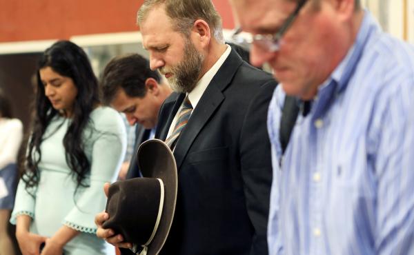 Libertarian activist Ammon Bundy (second from right) prays during an Easter Sunday church service he organized despite concerns over the coronavirus outbreak in Emmett, Idaho. Libertarian activist Ammon Bundy (second from right) prays during an Easter Sunday church service he organized despite concerns over the coronavirus outbreak in Emmett, Idaho.
