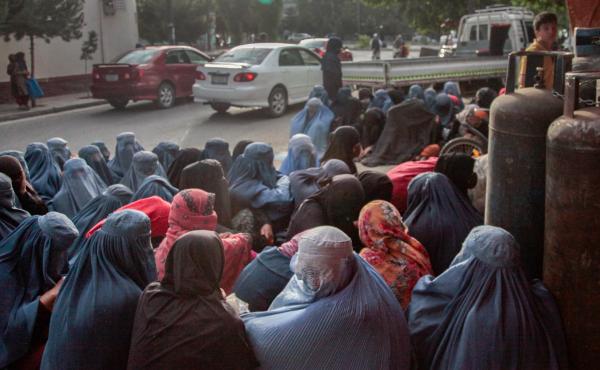 Women in burkas sit outside a bakery in Kabul. Impoverished women from hilltop slums around Kabul have been flocking to bakeries in the city, silently waiting to see if someone will purchase bread for them. Women in burkas sit outside a bakery in Kabul. Impoverished women from hilltop slums around Kabul have been flocking to bakeries in the city, silently waiting to see if someone will purchase bread for them.