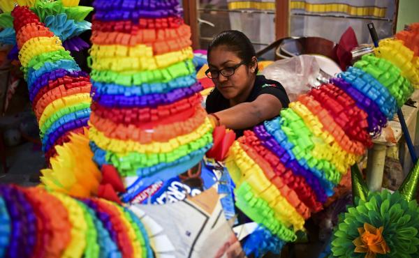 A woman prepares traditional Mexican piñatas for sale at a market in Acolman, Mexico state in 2017. A woman prepares traditional Mexican piñatas for sale at a market in Acolman, Mexico state in 2017.