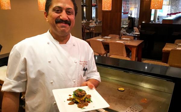 Rasika chef Vikram Sunderam, here with a towering dish of eggplant and potato, says, "Indian cuisine is a very personal cuisine. It's made from family to family, how they like to cook." Rasika chef Vikram Sunderam, here with a towering dish of eggplant and potato, says, "Indian cuisine is a very personal cuisine. It's made from family to family, how they like to cook."