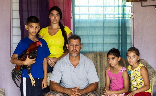 From left, José Yadiel Torres, 10, Lizmary Rivera, 29, José Torres, 38, and twins Janniela and Jamiléth Torres, 9, pose for a family portrait in their house in Utuado. The rooster, the family's most prized bird, is named Matatoro. From left, José Yadiel Torres, 10, Lizmary Rivera, 29, José Torres, 38, and twins Janniela and Jamiléth Torres, 9, pose for a family portrait in their house in Utuado. The rooster, the family's most prized bird, is named Matatoro.