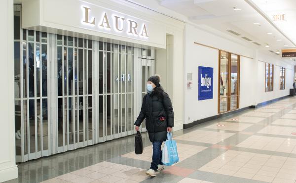 A woman walks by a closed store in a mall in Montreal on Jan. 2. A woman walks by a closed store in a mall in Montreal on Jan. 2.