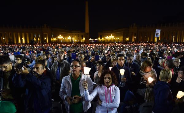 Faithful hold candles during a vigil prayer in preparation for the synod on the family on Oct. 4, at St. Peter's Square at the Vatican. Faithful hold candles during a vigil prayer in preparation for the synod on the family on Oct. 4, at St. Peter's Square at the Vatican.