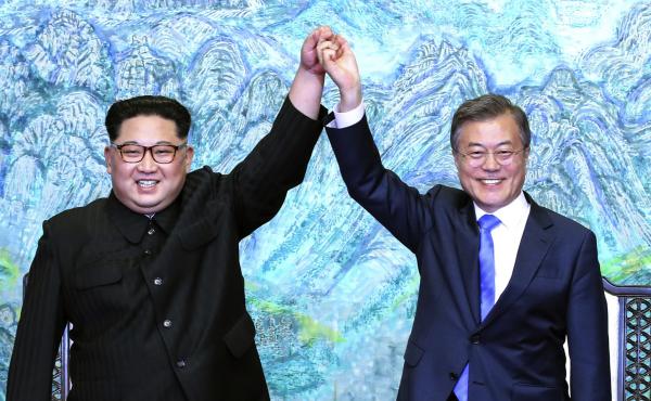 North Korean leader Kim Jong Un, left, and South Korean President Moon Jae-in raise their hands after signing a joint statement at the border village of Panmunjom. North Korean leader Kim Jong Un, left, and South Korean President Moon Jae-in raise their hands after signing a joint statement at the border village of Panmunjom.