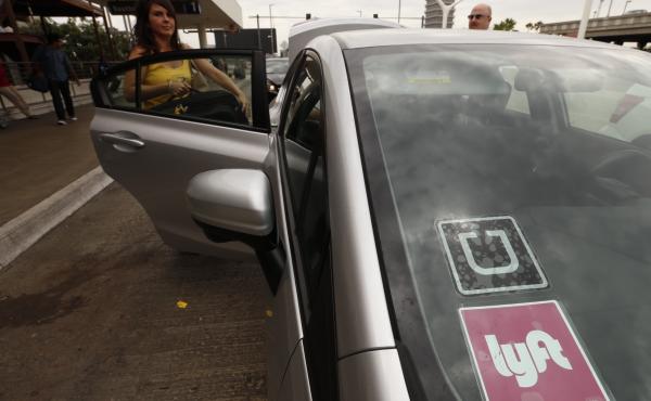 A car with Uber and Lyft stickers at Los Angeles International Airport. Uber dominates the fast growing ride hailing business. But Lyft is waging a spirited battle to keep up. A car with Uber and Lyft stickers at Los Angeles International Airport. Uber dominates the fast growing ride hailing business. But Lyft is waging a spirited battle to keep up.
