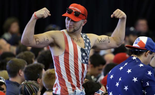 A Trump supporter flexes his muscles with the words "Build The Wall" written on his biceps, as Trump speaks at a campaign rally last year. A Trump supporter flexes his muscles with the words "Build The Wall" written on his biceps, as Trump speaks at a campaign rally last year.