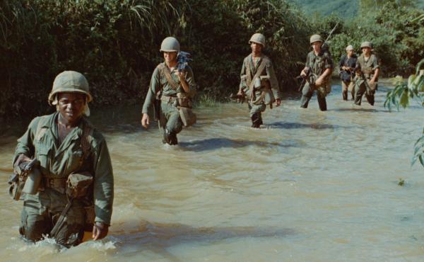 American soldiers advance through a rice paddy during the Vietnam War. American soldiers advance through a rice paddy during the Vietnam War.