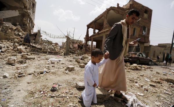 A man and a boy walk at a site hit by a Saudi-led air strike in Yemen's capital Sanaa on July 3. More than a million civilians have been displaced in recent fighting. A man and a boy walk at a site hit by a Saudi-led air strike in Yemen's capital Sanaa on July 3. More than a million civilians have been displaced in recent fighting.