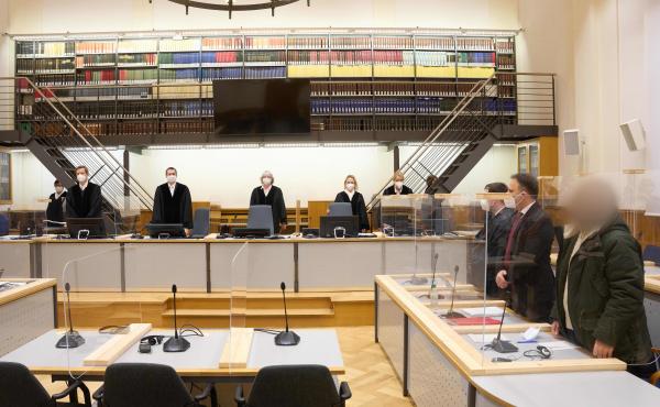 Defendant Anwar Raslan (right) and others involved in his trial stand in the Higher Regional Court in Koblenz, Germany, at the start of a trial session last month. Raslan was put on trial in April 2020 in a landmark case in Germany. Defendant Anwar Raslan (right) and others involved in his trial stand in the Higher Regional Court in Koblenz, Germany, at the start of a trial session last month. Raslan was put on trial in April 2020 in a landmark case in Germany.