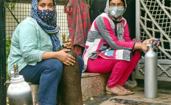India has reported more than 20 million coronavirus cases, adding more than 2.6 million new cases in the past week alone. Here, women wait to refill empty oxygen cylinders in New Delhi. Oxygen shortages are blamed for deaths at even the best-equipped urba India has reported more than 20 million coronavirus cases, adding more than 2.6 million new cases in the past week alone. Here, women wait to refill empty oxygen cylinders in New Delhi. Oxygen shortages are blamed for deaths at even the best-equipped urba