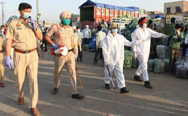Punjab police patrol at a vegetable wholesale market during a nationwide lockdown against the spread of COVID-19, on the outskirts of Amritsar on May 1. Punjab police patrol at a vegetable wholesale market during a nationwide lockdown against the spread of COVID-19, on the outskirts of Amritsar on May 1.