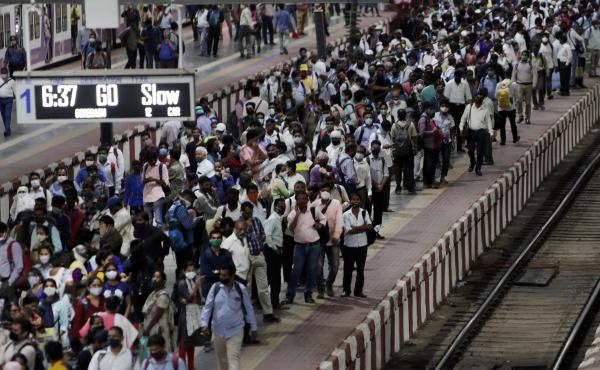 Commuters wait to board a suburban train on Tuesday at Chhatrapati Shivaji Maharaj Terminus prior to the night curfew that has been introduced to curb the spread of COVID-19 in Mumbai. Commuters wait to board a suburban train on Tuesday at Chhatrapati Shivaji Maharaj Terminus prior to the night curfew that has been introduced to curb the spread of COVID-19 in Mumbai.