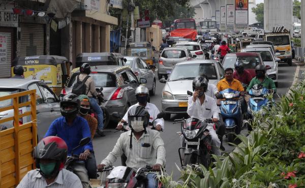 People wearing face masks ride past a busy street on Friday in Hyderabad, India. India crossed 1 million coronavirus cases on Friday, third only to the United States and Brazil. People wearing face masks ride past a busy street on Friday in Hyderabad, India. India crossed 1 million coronavirus cases on Friday, third only to the United States and Brazil.